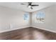 Cozy bedroom featuring hardwood floors, a ceiling fan, and natural light from two large windows at 8616 Port Said St, Orlando, FL 32817