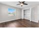Well-lit bedroom with closet space, ceiling fan, and hardwood floors for a comfortable living space at 8616 Port Said St, Orlando, FL 32817