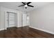 A bedroom featuring hardwood floors, a ceiling fan, and a spacious closet at 8616 Port Said St, Orlando, FL 32817
