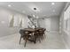 Stylish dining room with modern light fixture, contemporary art, and access to the staircase at 8616 Port Said St, Orlando, FL 32817