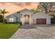 Charming single-Gathering home featuring modern architecture, a well-manicured lawn, and a brick-paved driveway at 8616 Port Said St, Orlando, FL 32817