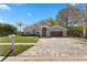 Charming home showcasing professional landscaping and a paver driveway leading to a two-car garage at 8616 Port Said St, Orlando, FL 32817
