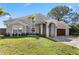 Well-kept home with lush front lawn, stone-accented facade, and a stylish garage door at 8616 Port Said St, Orlando, FL 32817