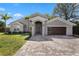 Lovely home with a welcoming entrance and a paver driveway leading to a modern garage at 8616 Port Said St, Orlando, FL 32817