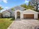 Beautiful single-Gathering home featuring modern architecture, a well-manicured lawn, and a brick-paved driveway at 8616 Port Said St, Orlando, FL 32817