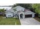 Beautiful home features a two-car garage, a walkway, and well-maintained landscaping at 8616 Port Said St, Orlando, FL 32817