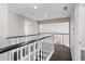 An upstairs hallway featuring hardwood floors and white railing at 8616 Port Said St, Orlando, FL 32817