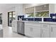 Bright kitchen featuring white cabinets, stainless steel appliances, and blue backsplash at 8616 Port Said St, Orlando, FL 32817