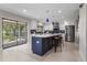 Modern kitchen with stainless steel appliances, large island, and sliding glass doors to backyard at 8616 Port Said St, Orlando, FL 32817