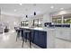 Open-concept kitchen featuring a large island with quartz countertop, bar seating and stainless appliances at 8616 Port Said St, Orlando, FL 32817