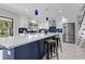 Spacious kitchen featuring a large island with seating, white cabinets, blue tile and stainless appliances at 8616 Port Said St, Orlando, FL 32817