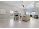 Bright living room featuring a fireplace, neutral decor, high ceilings, and lake views through sliding glass doors at 8616 Port Said St, Orlando, FL 32817