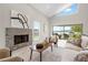 Cozy living room with stone fireplace, large windows overlooking waterfront at 8616 Port Said St, Orlando, FL 32817