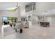 Bright, open-concept living room with high ceilings, neutral decor, and access to outdoor seating area at 8616 Port Said St, Orlando, FL 32817
