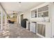 Covered patio with pavers, ceiling fan, outdoor kitchen, and built-in stainless steel refrigerator at 8616 Port Said St, Orlando, FL 32817