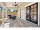 Relaxing covered patio featuring brick flooring, a ceiling fan, and comfortable seating next to the french doors at 8616 Port Said St, Orlando, FL 32817