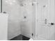 Modern walk-in shower with tiled walls, glass door, and sleek fixtures in a renovated bathroom at 8616 Port Said St, Orlando, FL 32817