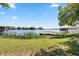 Picturesque lakefront view with a dock, surrounded by lush greenery, perfect for fishing or boating activities at 8616 Port Said St, Orlando, FL 32817