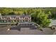 Aerial view of modern townhomes with parking, surrounded by lush green trees and landscaping at 8802 Positivity Dr, Kissimmee, FL 34747