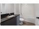 Bathroom features a modern vanity with granite counters and shower-tub combination at 8802 Positivity Dr, Kissimmee, FL 34747