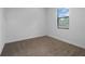 Bedroom features neutral-colored walls, carpet flooring, and natural light from window at 8802 Positivity Dr, Kissimmee, FL 34747