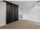 Bedroom features a sliding-door closet, neutral carpet, and white walls at 8802 Positivity Dr, Kissimmee, FL 34747