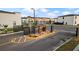 Community entrance with a modern fence and signage, leading to townhomes in the distance at 8802 Positivity Dr, Kissimmee, FL 34747