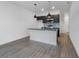 Modern kitchen with a center island, sleek dark cabinetry, and stylish pendant lighting at 8802 Positivity Dr, Kissimmee, FL 34747