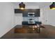 Modern kitchen features sleek black cabinetry, stainless steel appliances, and granite countertops at 8802 Positivity Dr, Kissimmee, FL 34747