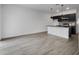 Spacious living area with modern black kitchen, island seating, and light gray flooring at 8802 Positivity Dr, Kissimmee, FL 34747