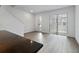 Bright living room with an open concept, laminated floors, and access to the front yard at 8802 Positivity Dr, Kissimmee, FL 34747