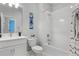 Bright bathroom featuring a tub, shower, and sleek modern vanity and fixtures at 9250 Neher St, Orlando, FL 32827