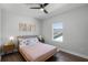 Bright bedroom with wood floors, ceiling fan and natural light from the window at 9250 Neher St, Orlando, FL 32827
