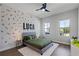 Decorated bedroom with a soft rug, accent wall and plenty of sunlight from the dual windows at 9250 Neher St, Orlando, FL 32827