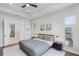 Cozy bedroom with modern décor, including stylish lighting, artwork, and a comfortable bed at 9250 Neher St, Orlando, FL 32827