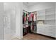 Spacious walk-in closet featuring custom shelves and direct bathroom access at 9250 Neher St, Orlando, FL 32827