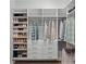 This custom walk-in closet features shoe shelves and storage for ample space at 9250 Neher St, Orlando, FL 32827