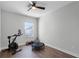 Workout area with an exercise bike, rebounder, and natural light from the window at 9250 Neher St, Orlando, FL 32827