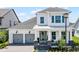 Charming two-story home featuring a two-car garage, inviting front porch, and meticulously landscaped front yard at 9250 Neher St, Orlando, FL 32827