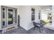 Inviting front porch with decorative welcome sign, comfortable seating, and stylish gray brick flooring at 9250 Neher St, Orlando, FL 32827