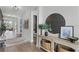 Elegant hallway with wood floors, decorative console table, and a modern mirror at 9250 Neher St, Orlando, FL 32827