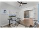 Bright home office with wood floors, ceiling fan, and large monitors on the sleek, modern desk at 9250 Neher St, Orlando, FL 32827