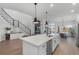 Open concept kitchen with a center island, modern appliances, and seamlessly flowing living spaces at 9250 Neher St, Orlando, FL 32827