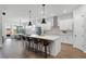 Bright modern kitchen featuring a large island with pendant lighting and sleek white cabinets at 9250 Neher St, Orlando, FL 32827