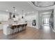 Spacious open-concept kitchen with white cabinets, island with seating, and stainless steel appliances at 9250 Neher St, Orlando, FL 32827