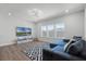 Cozy living room with a comfortable sofa, large windows, and modern entertainment setup at 9250 Neher St, Orlando, FL 32827