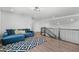 Second-floor living room featuring a blue couch, black and white rug, and modern railings at 9250 Neher St, Orlando, FL 32827
