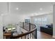 Bright and open living room viewed from the staircase, featuring large windows and modern decor at 9250 Neher St, Orlando, FL 32827