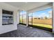 Covered patio with brick flooring, offering a view of the backyard and surrounding houses at 9250 Neher St, Orlando, FL 32827