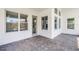 Inviting covered patio area with brick flooring, providing ample natural light and outdoor access at 9250 Neher St, Orlando, FL 32827